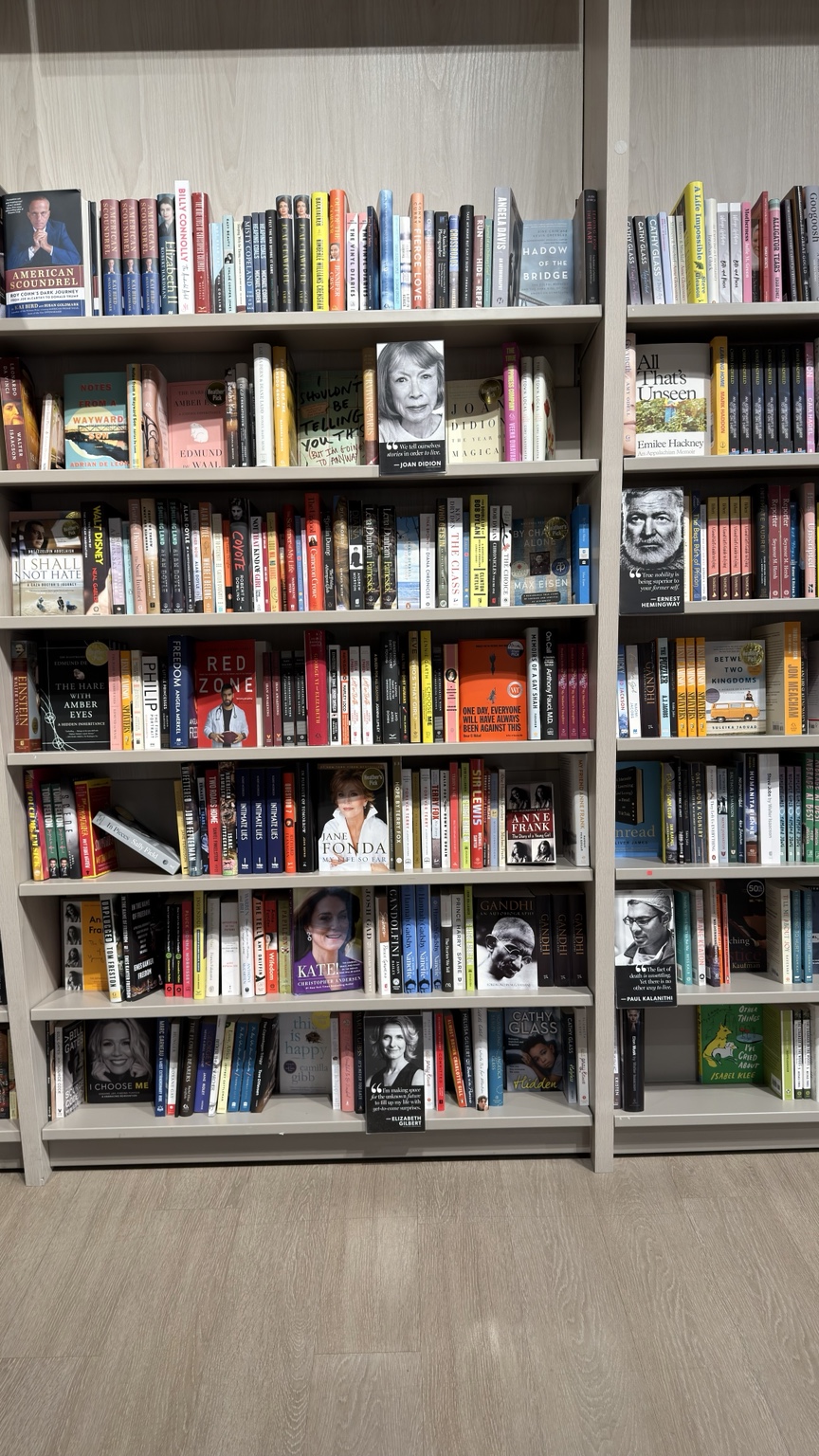 A full wall of bookstore shelves photographed by Aman